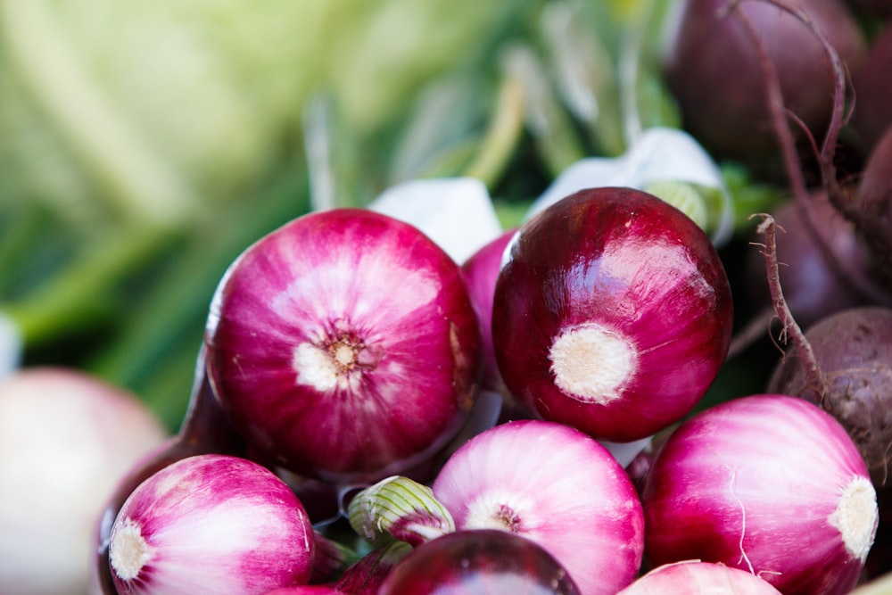 Red onions and beets stacked in a basket at the farmer's market