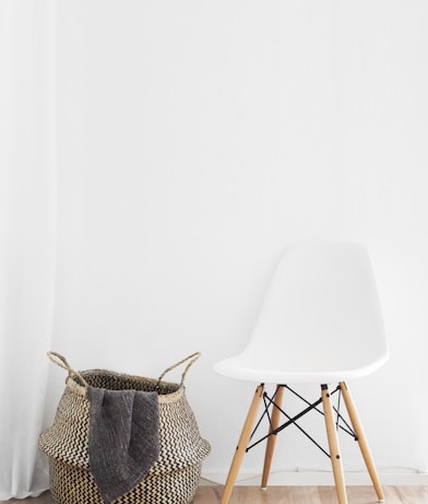 white and brown chairs beside wicker basket near white wall