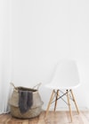 white and brown chairs beside wicker basket near white wall