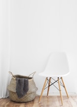 white and brown chairs beside wicker basket near white wall