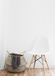 white and brown chairs beside wicker basket near white wall