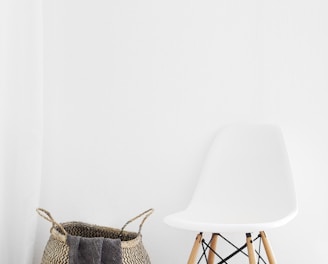 white and brown chairs beside wicker basket near white wall