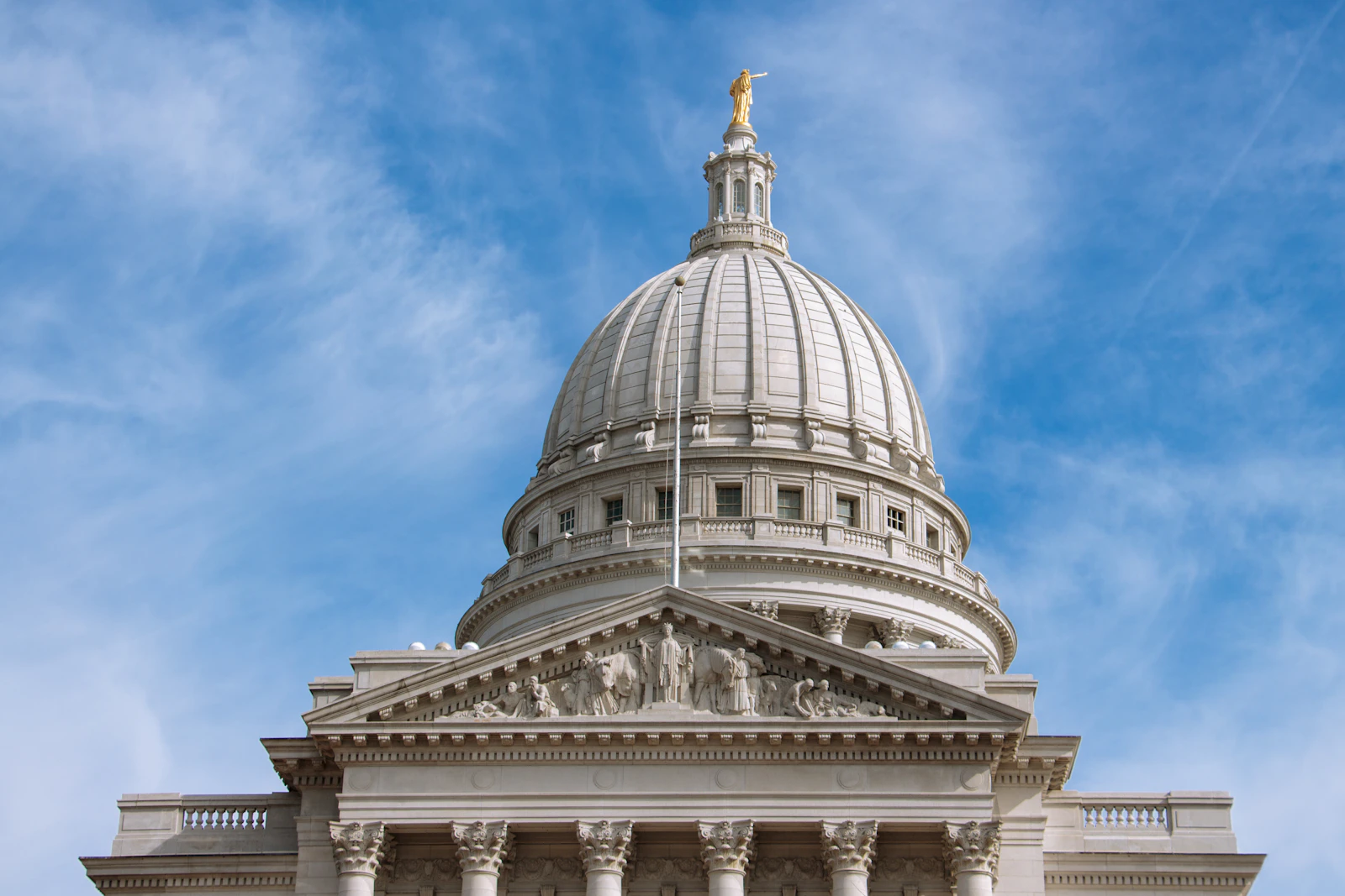 The Wisconsin State Capitol in Madison, Wisconsin, seen against a blue sky