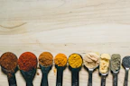 Colorful measuring spoons and cups neatly organized on a countertop.