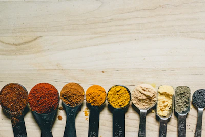 A colorful array of measuring spoons and cups neatly arranged on a marble countertop.
