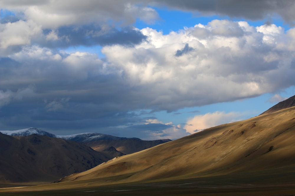 brown mountain under white sky