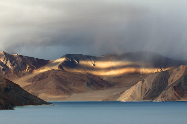 Sunlight glistening on the salt pans of Cuyutlán with mountains in the distance.