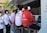 Several people wearing Citroën Racing uniforms and headphones are seated at a technical workstation with laptops and screens. They appear focused on monitoring or analyzing data.