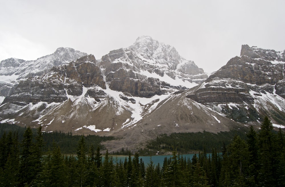 mountains covered with snow near body of water