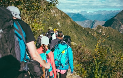 people walking beside the mountain