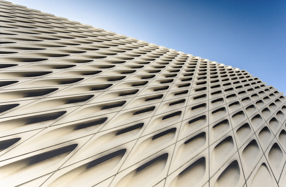 a tall white building with a sky in the background