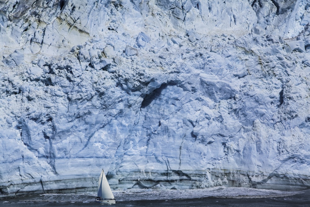 white sailboat near mountain