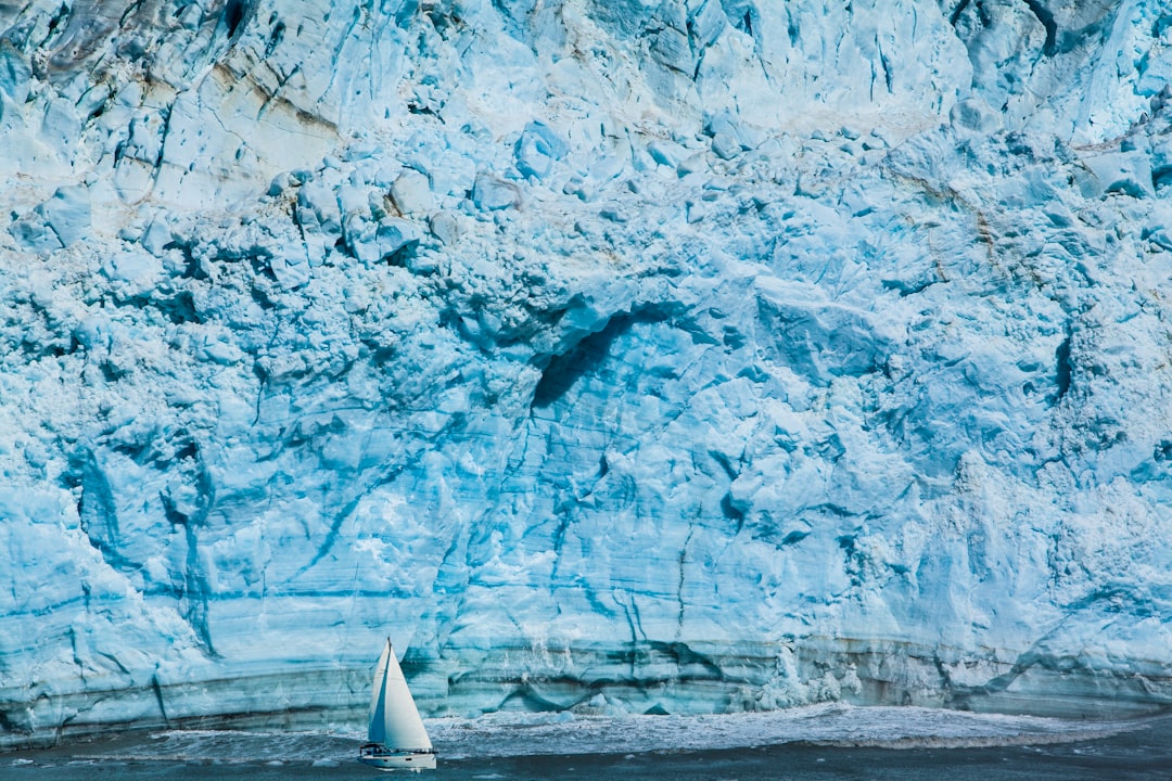 white sailboat near mountain