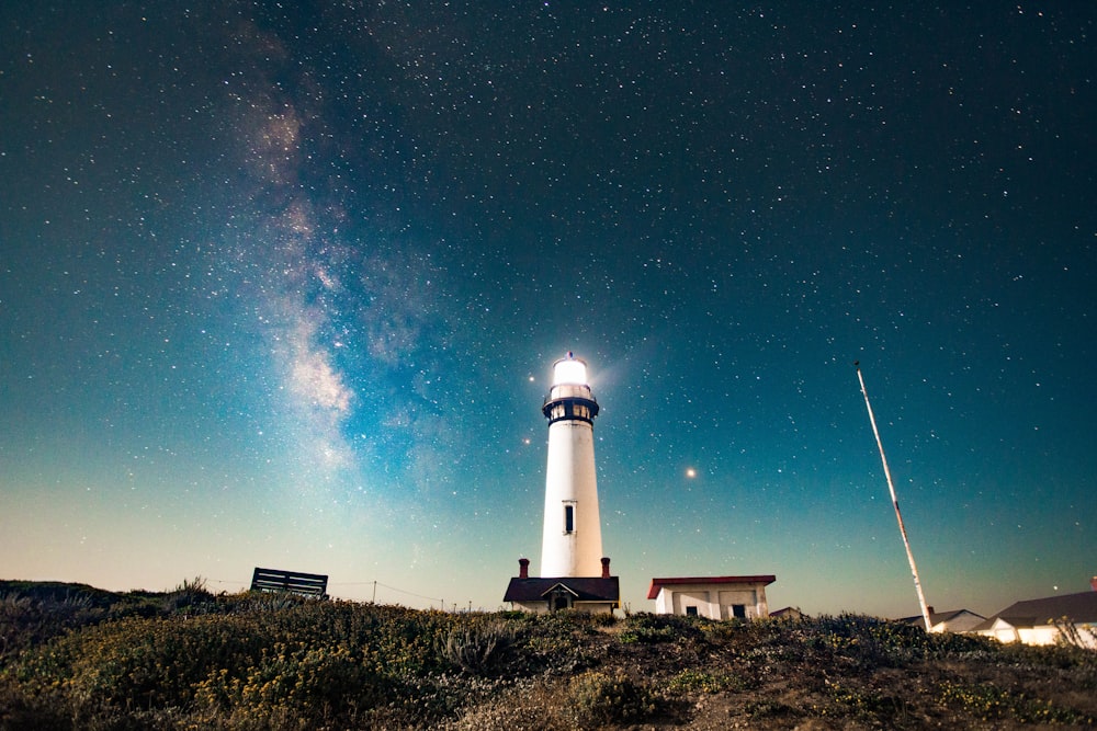 photo of turned on white lighthouse