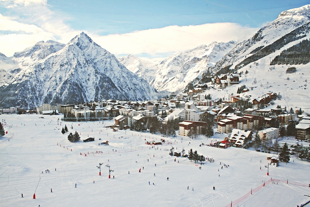 a ski resort surrounded by snow covered mountains