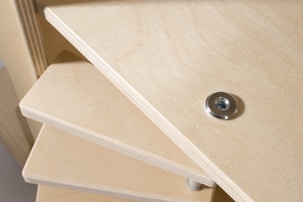 Close-up of hands fixing wardrobe hinges and shelves during installation.