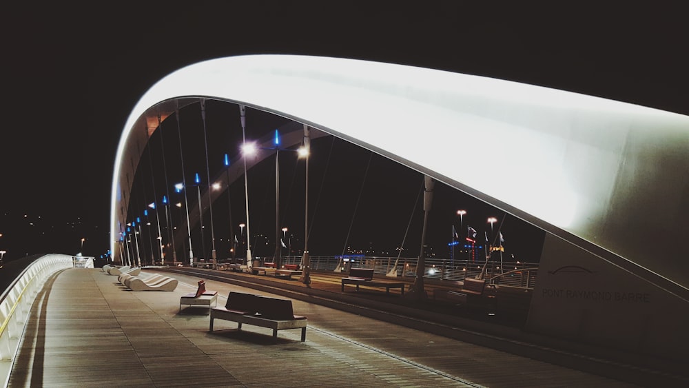 brown wooden sofa on concrete road at night