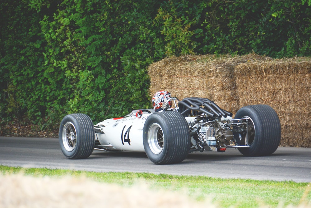 person on white racing car