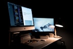 silver iMac turned on inside room