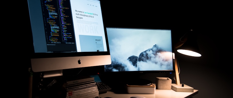 silver iMac turned on inside room