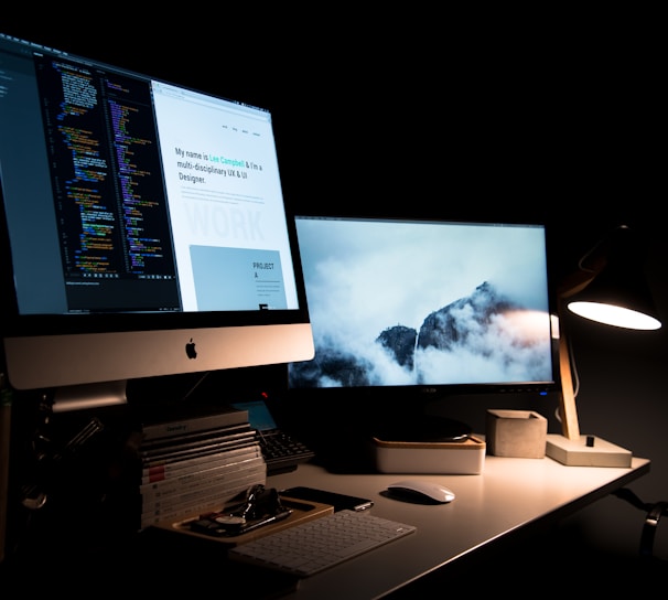 silver iMac turned on inside room