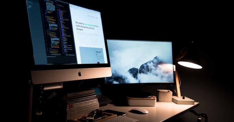 silver iMac turned on inside room