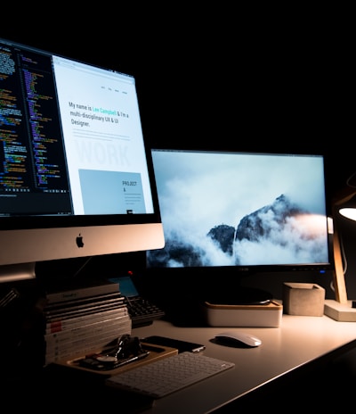 silver iMac turned on inside room