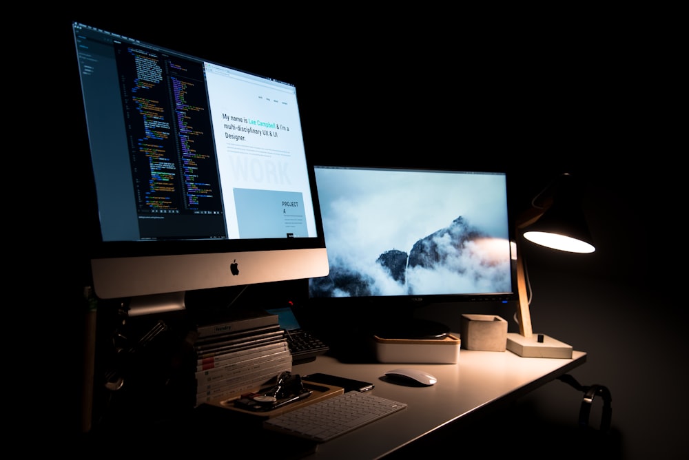 silver iMac turned on inside room