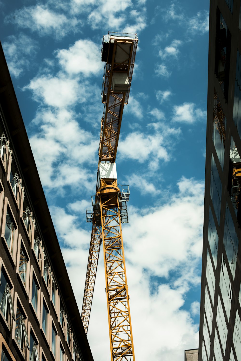 orange metal crane under blue sky during daytime