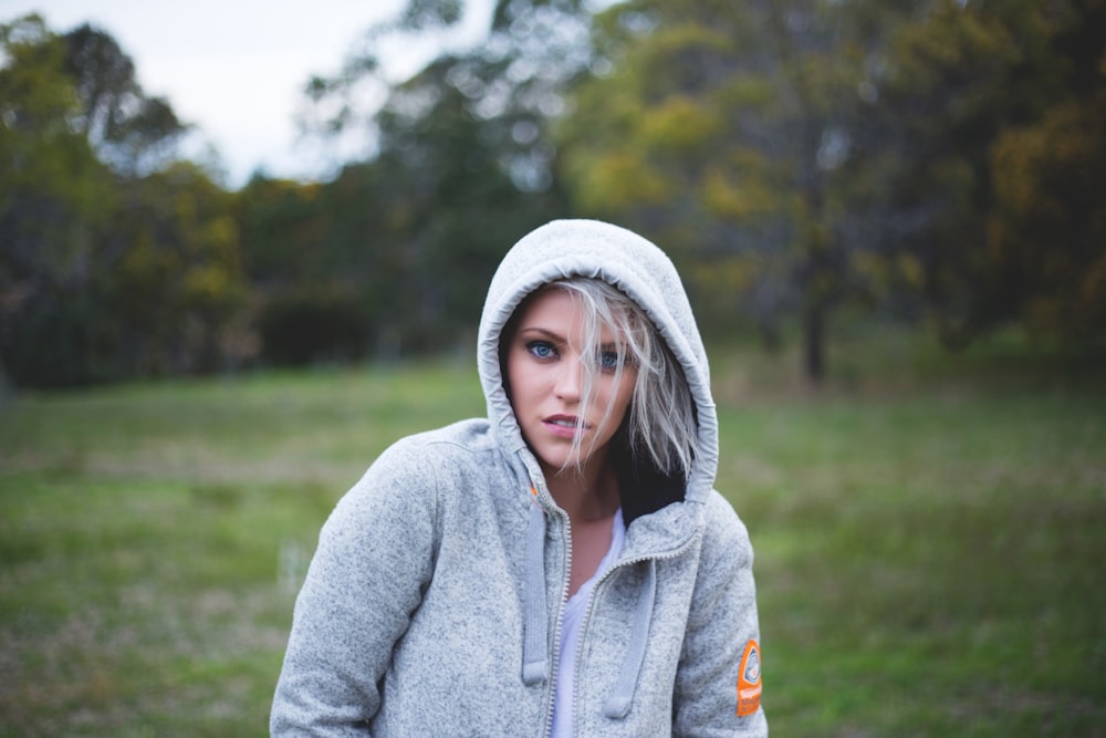 tilt-shift lens photography of woman on a green grass