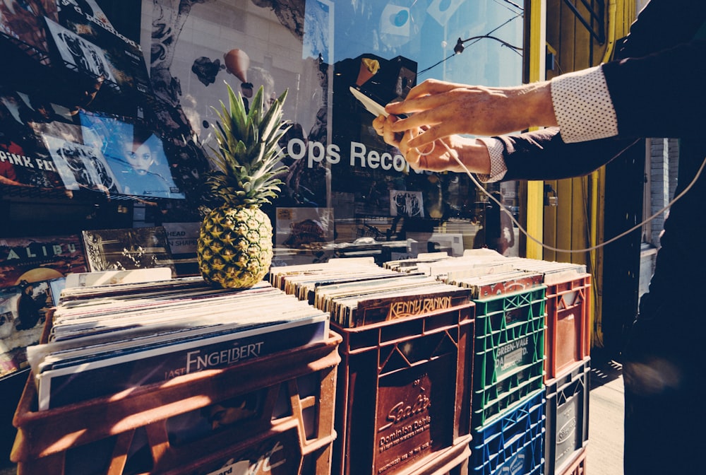 a person standing next to a pile of records