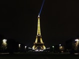 Nighttime view of the Eiffel Tower sparkling, seen from the hotel terrace.