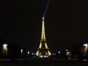 Nighttime view of the Eiffel Tower sparkling, seen from the hotel terrace.