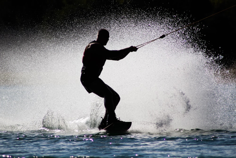 silhouette of man kite boarding