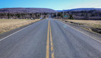 Wide open countryside roads stretching toward distant hills.