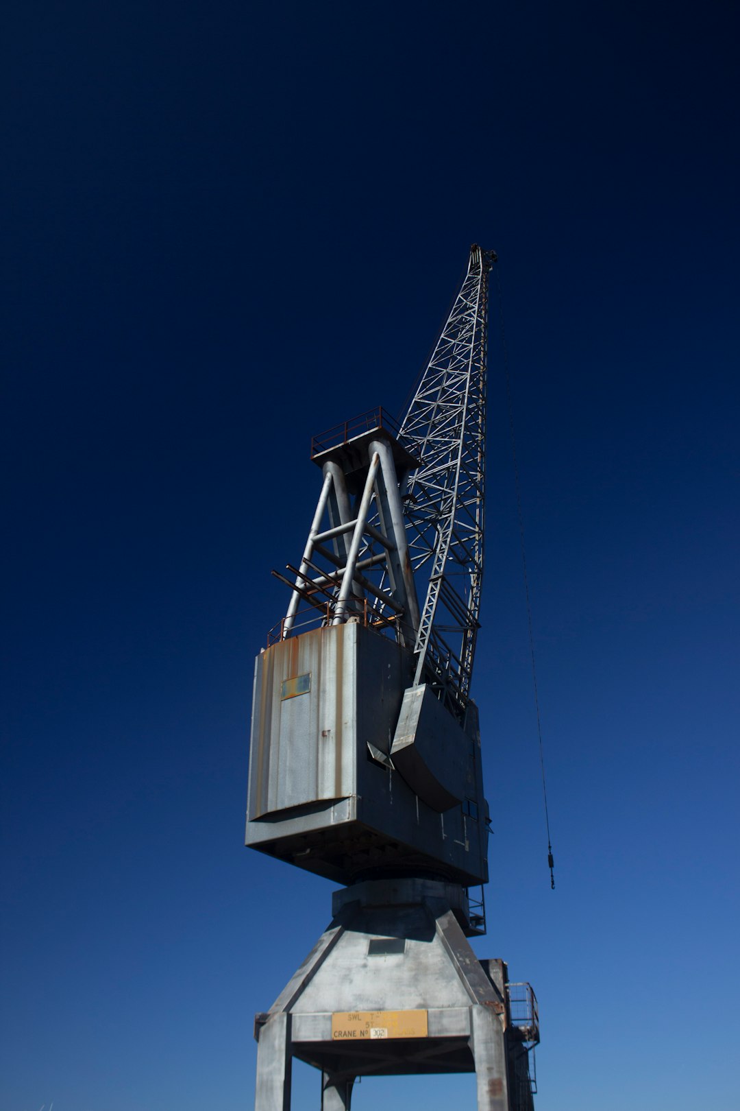 gray metal crane equipment under blue sky