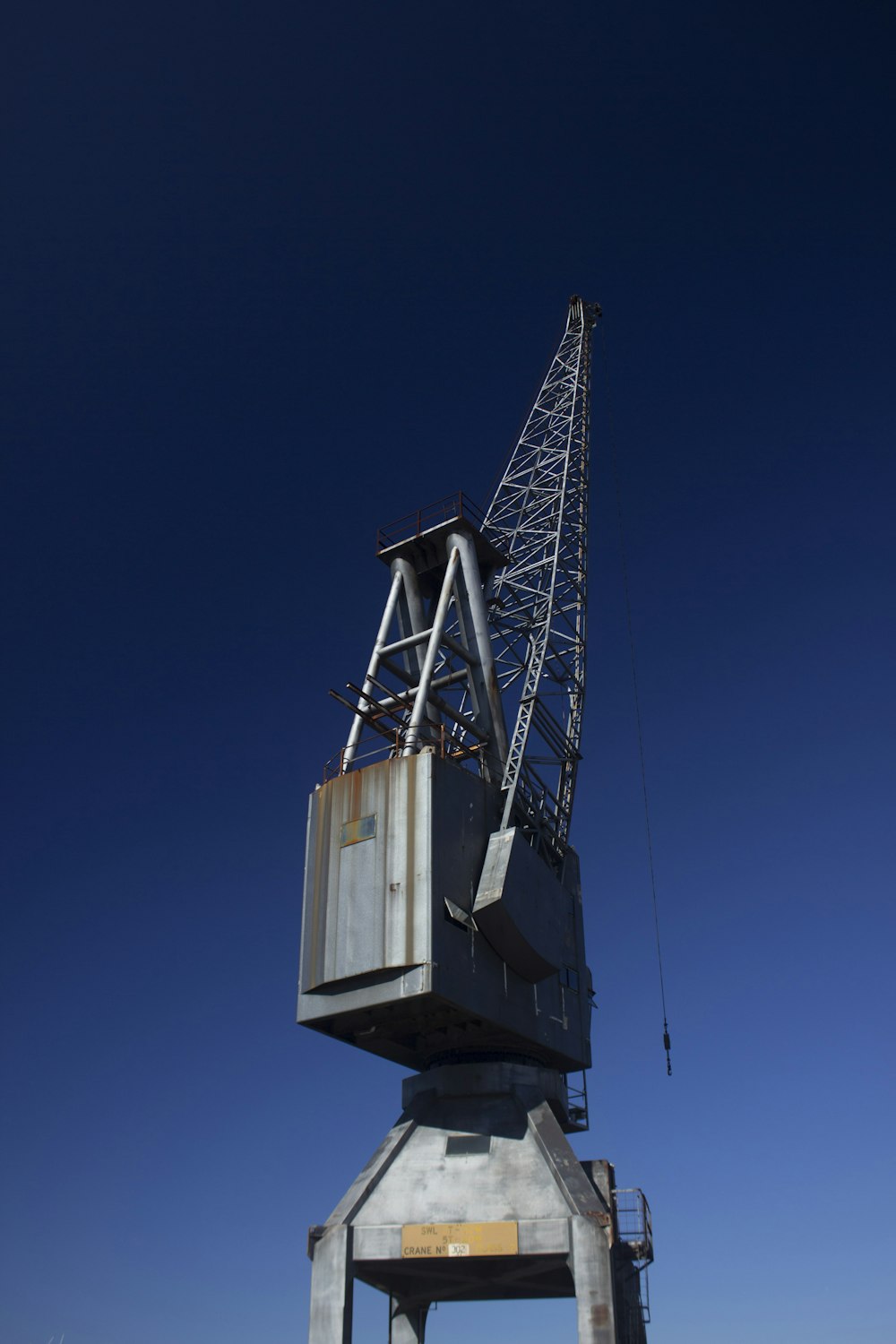 gray metal crane equipment under blue sky
