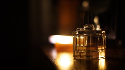 A cozy, elegant perfume bottle on a vintage wooden table with soft natural light.