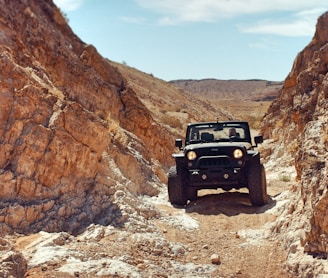 black sport utility vehicle near rock formations