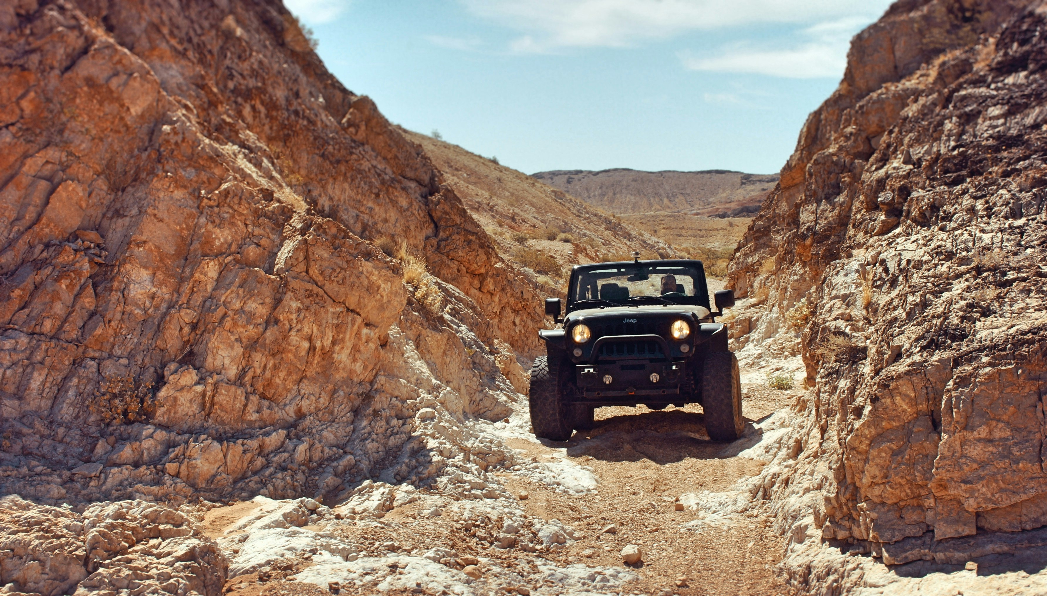 black sport utility vehicle near rock formations