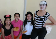 Close-up of a group of friends laughing together, wearing handmade One Piece accessories.