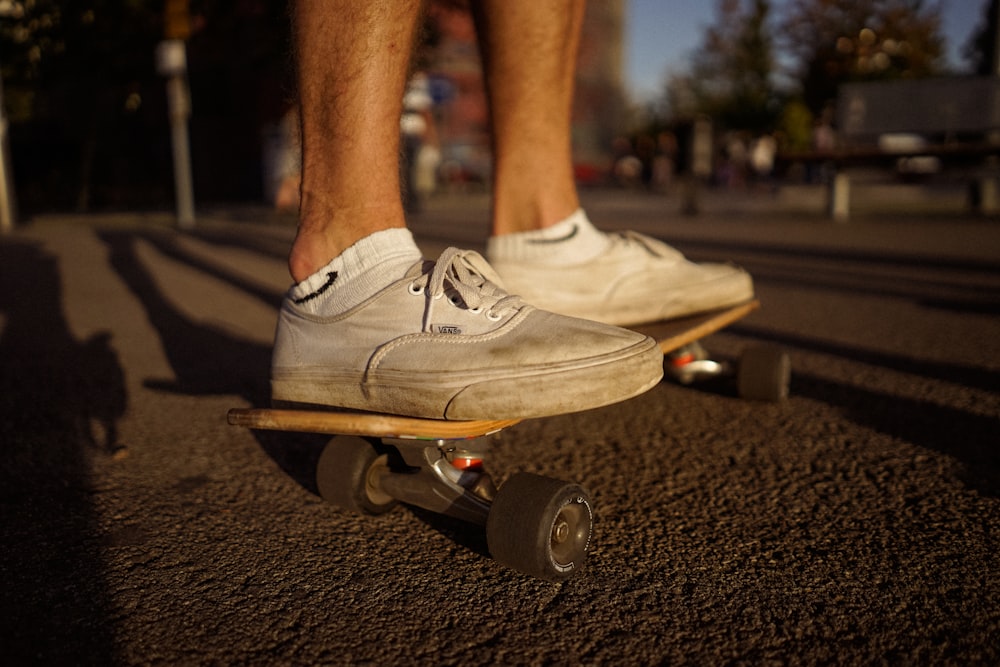 person on top of skateboard on gray pavement