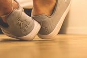 Close-up of wrestling shoes on a gym floor.