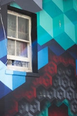 Close-up of a colorful 3D printed wall mural featuring geometric patterns in a modern office space.