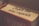 A close-up of a book with the words 'From the real experts' written on the spine. The book has a warm color palette with hints of red and beige, and is titled 'The Ultimate Insiders' Guide' with parts of the title obscured.