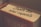 A close-up of a book with the words 'From the real experts' written on the spine. The book has a warm color palette with hints of red and beige, and is titled 'The Ultimate Insiders' Guide' with parts of the title obscured.