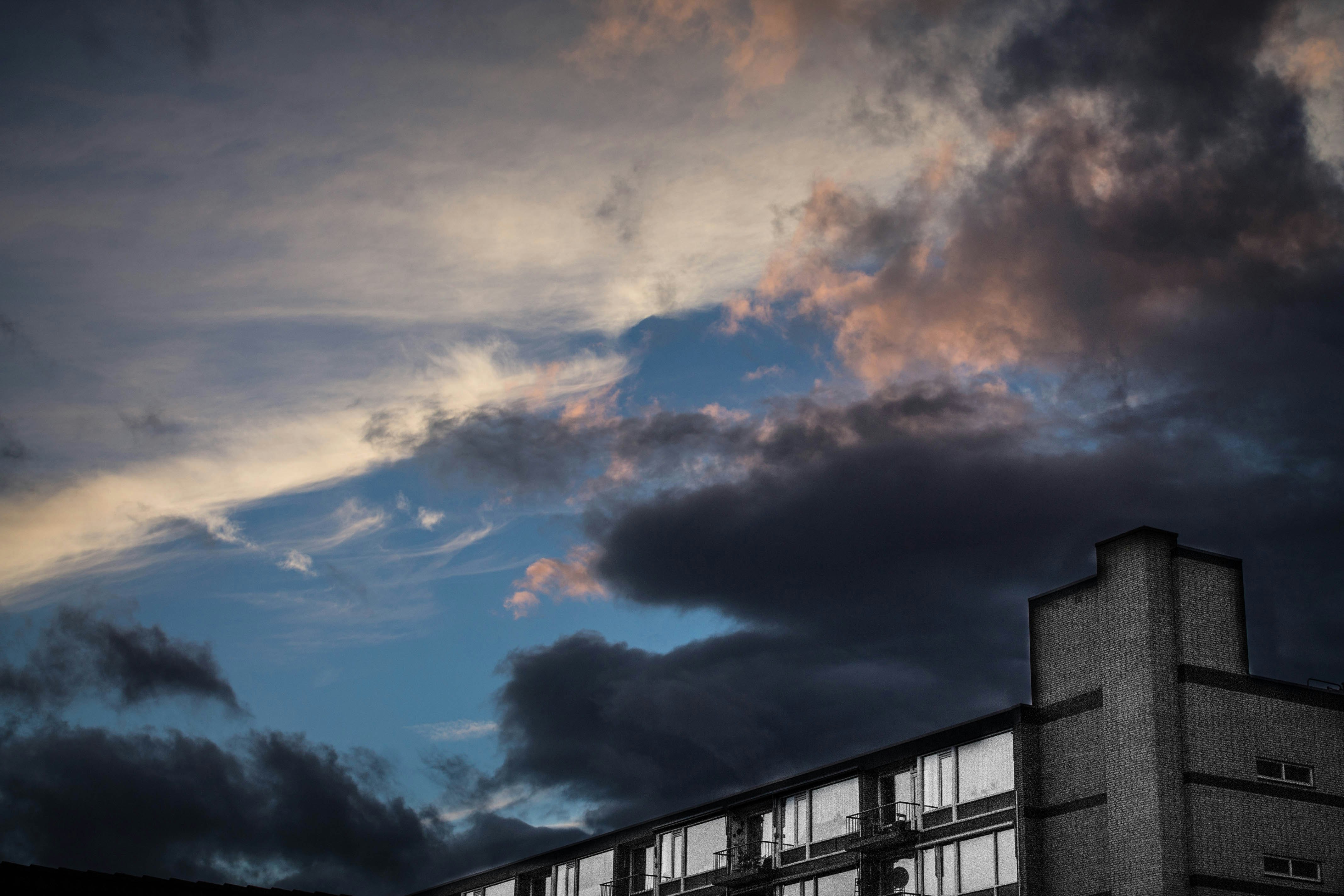 landscape photography of white building under dark cloudy sky