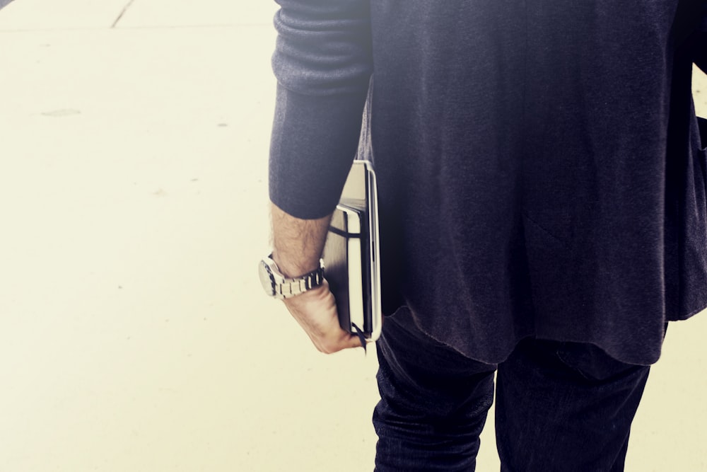 person holding books close-up photography