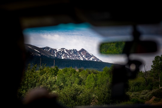 lowlight photography of rock formation beside forest in US National Park Road United States