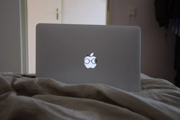 Detailed shot of custom vinyl decals being applied to a laptop surface.